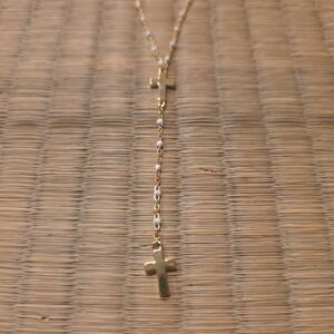 Delicate gold toned cross necklace